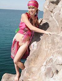 Wearing her pots fanny costume, Firebird's alluring belle stands out painless she bravely poses along the rocky cliff by the sea.